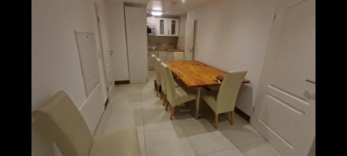 a dining room with a wooden table and chairs at Pauline in Loxstedt