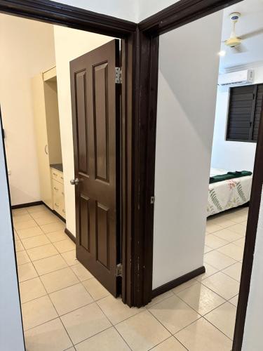 a room with two doors and a tile floor at Ambitious Apartment Nadi in Nadi