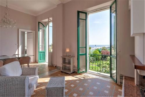 a living room with sliding glass doors with a view at [- Poetic Seafront Penthouse Versilia -] in Massa
