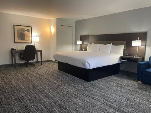 a hotel room with a bed and a desk and a chair at Best Western DuBois Hotel in DuBois