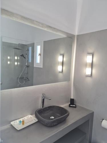 a bathroom with a stone sink on a counter at Zoumis Residence in Naousa