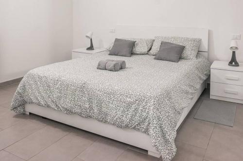 a bedroom with a large bed with a leopard print blanket at Staurenghi Blue Apartment in Varese