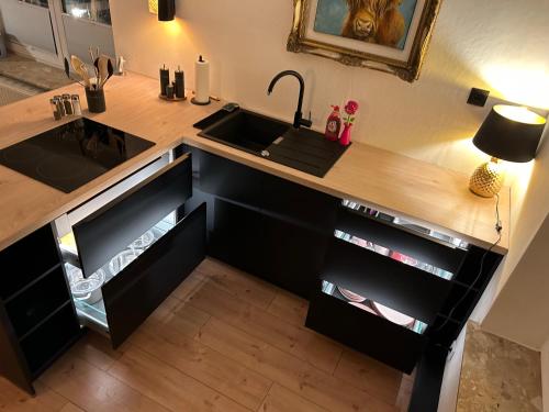 a kitchen with a sink and a wooden counter top at Appartement fliegender Hirsch in Bäk