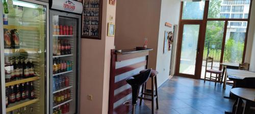 a bar in a restaurant with a drink refrigerator at Hotel 415 in Sunny Beach