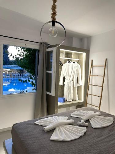 a bedroom with a bed with two towels on it at Zoumis Residence in Naousa