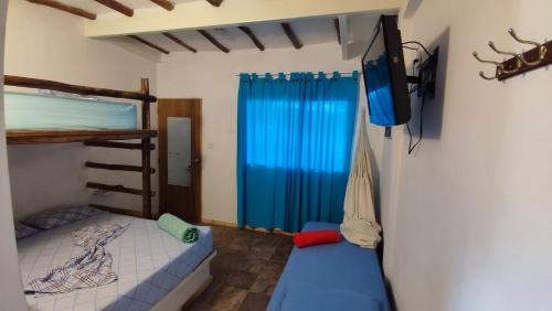 a bedroom with a bed and a tv in a room at Casaione in Puerto Colombia