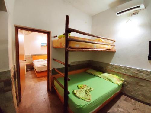 a room with two bunk beds and a mirror at Casaione in Puerto Colombia