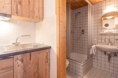 a bathroom with a sink and a shower at Gästehaus Bergstüberl in Reit im Winkl