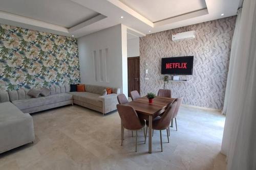 een woonkamer met een tafel en een bank bij sea view villa with garden in Agadir