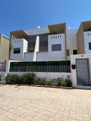 a large white building with a fence in front of it at sea view villa with garden in Agadir