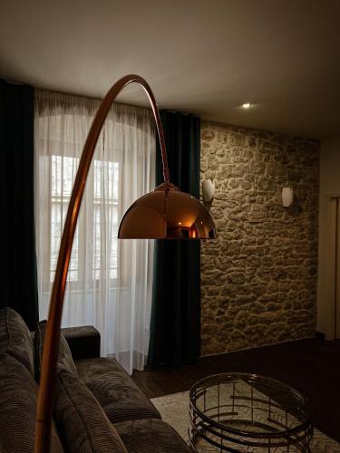 a lamp in a living room with a couch at Borna and Franko Rooms Split city centre in Split