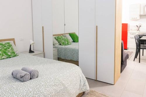 a bedroom with a bed with two pillows on it at Staurenghi Green Apartment in Varese