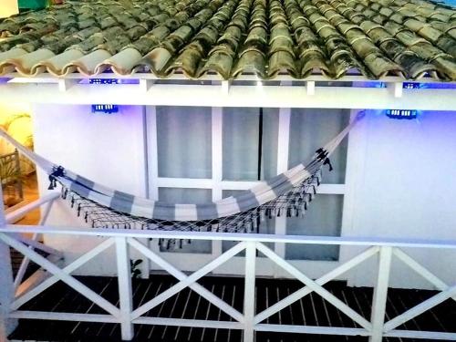 a hammock hanging from the side of a building at Porto Mar de Búzios in Búzios