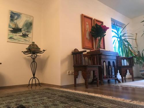 a living room with a table and chairs and a table with flowers at Bei Annerl in Gmunden