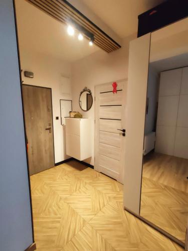 a room with a door and a wooden floor at Apartament Radio Tower in Gliwice