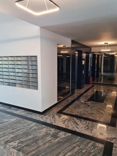 a dressing room with wood flooring and mirrors at Matteo 2 Apartments Marina Surf Residence, Mamaia Nord - Năvodari,1 vedere frontala,2 cu vedere laterala la mare in Năvodari