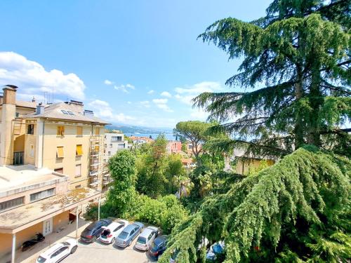 a view of a city with cars parked in a parking lot at Apartman Koli Opatija in Opatija