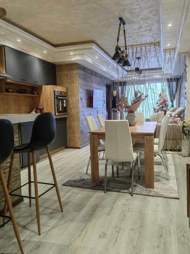 a kitchen and dining room with a table and chairs at Premium Urban Life in Zaječar