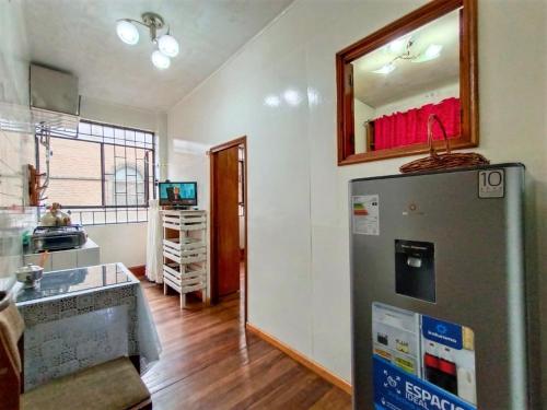 a kitchen with a refrigerator and a mirror on the wall at APARTAMENTO COMPLETO LIMA - 2 cuadras del Palacio Gobierno in Lima