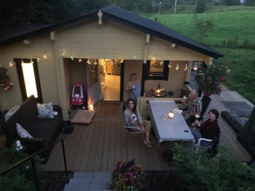 a group of people sitting on a patio at Country Cabin Omagh in Omagh