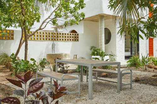 a table and two benches in a garden at APT by DW in San Juan