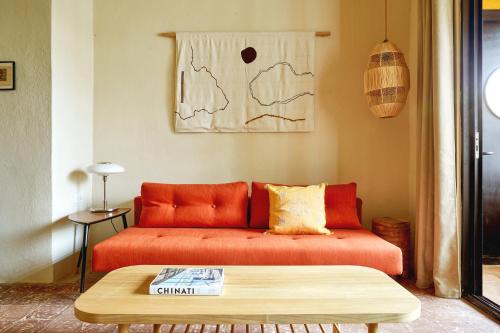 a living room with an orange couch and a coffee table at APT by DW in San Juan