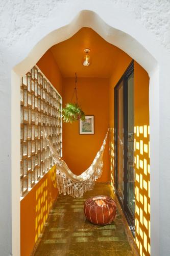 an orange room with a hammock in the corner at APT by DW in San Juan