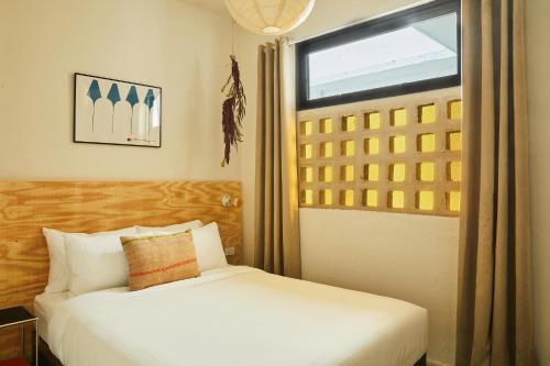 a bedroom with a bed and a window at APT by DW in San Juan