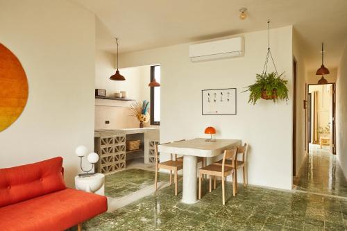 a living room with a table and a red couch at APT by DW in San Juan