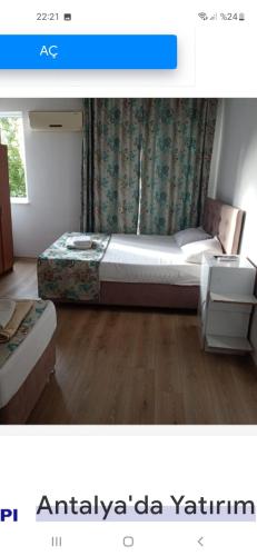 een kleine slaapkamer met een bed en een dressoir bij Kınay pansiyon in Belek