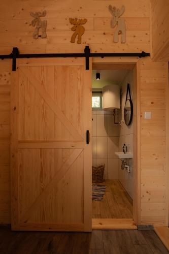 a barn door opens up to a bathroom at Groszkówka 2 in Narewka