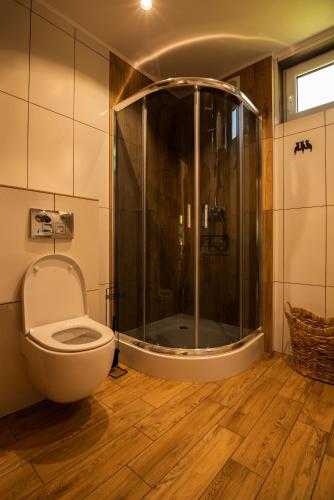 La salle de bains est pourvue d'une douche et de toilettes. dans l'établissement Groszkówka 2, à Narewka