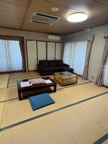 a living room with a couch and a table at Enmanin Sanmitsuden - Vacation STAY 40281v in Otsu