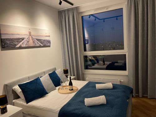 a bedroom with a bed and a large window at Zaspa VVita Sea View Apartment in Gdańsk