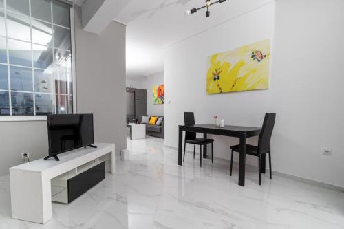 a dining room with a table and a tv at Z5 Sky Sparta Apartment in Sparta