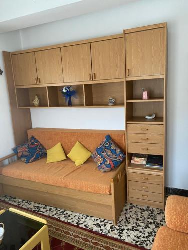 a bed in a room with wooden cabinets at Casa Roque in Monforte de Lemos