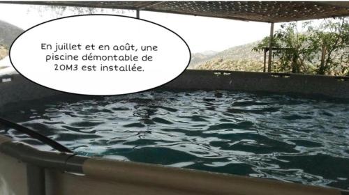 a bath tub with water in it with a speech bubble at Auberge Village Paradise Valley in Tagherat Anekrim