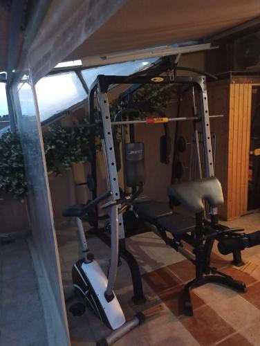 a gym with a tread machine in a room at Kellys house in Epanomi