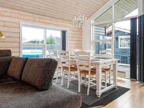 a dining room with a white table and chairs at 6 person holiday home in Juelsminde-By Traum in Sønderby