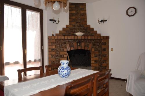 a blue and white vase sitting on a table in a living room at Villa Magnolia in Pian di Mulino