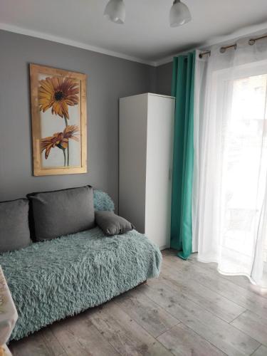 a living room with a bed and a window at 4 Foxes in Ustka