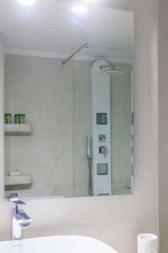 a bathroom with a sink and a mirror at Aerno Home & Azul Ηοme - Ahilli Slow Living in Kamari
