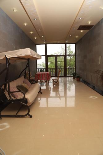 a large room with a bed and a table at Eriks guest house in Goris