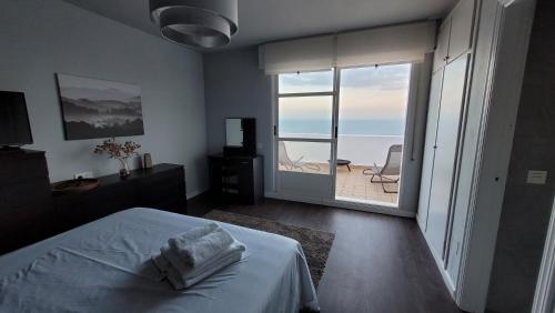 a bedroom with a bed and a view of the ocean at Mirador de aguadulce in Aguadulce