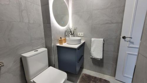 a bathroom with a toilet and a sink and a mirror at Mirador de aguadulce in Aguadulce