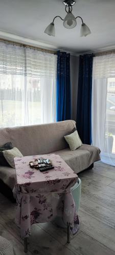 a living room with a couch and a table at 4 Foxes in Ustka
