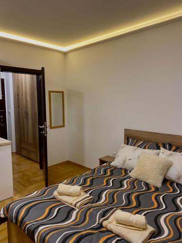 a bedroom with a bed with two towels on it at Studio Rilak in Vrnjačka Banja