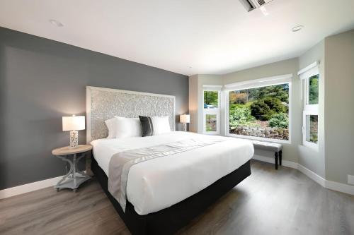 a bedroom with a large white bed and a window at High Point Guesthouse - Next to Seattle Chinese Garden in Seattle