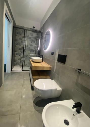 a bathroom with a white toilet and a sink at Acquamarina Casa Vacanze in Marina San Vito