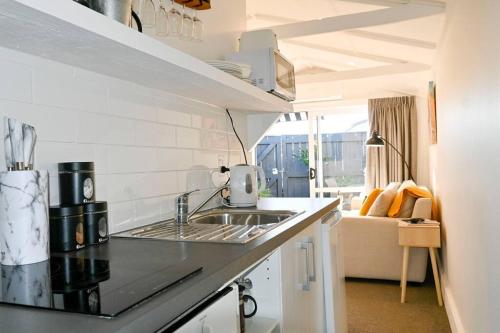 uma cozinha com um lavatório e uma bancada em Modern and Private Guesthouse with Hot Tub located 500m to Havelock North Village em Havelock North